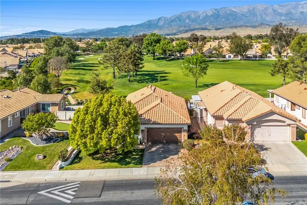 an aerial view of a house with a garden and lake view