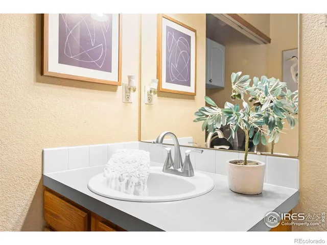 a vase of flowers sitting on a bathroom sink