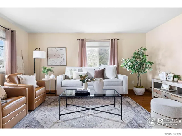 a living room with furniture potted plant and window
