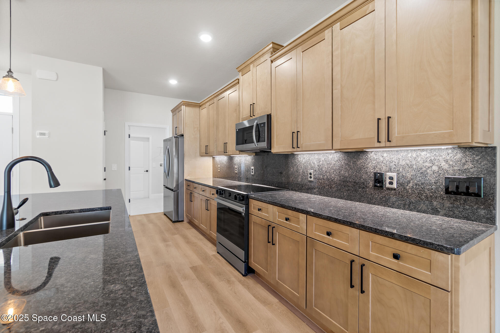 1541 Madison Road Northwest Palm Bay, FL 32907 - Photo 13 of 62 a kitchen with stainless steel appliances granite countertop a sink a stove and a refrigerator
