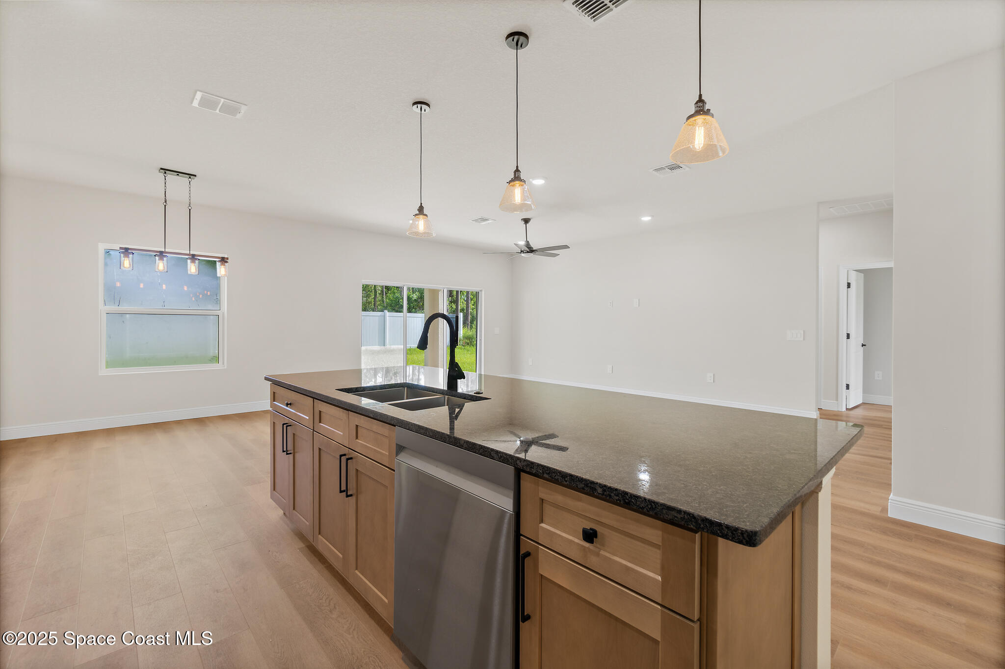 1541 Madison Road Northwest Palm Bay, FL 32907 - Photo 17 of 62 a kitchen with a sink a counter space and wooden floor