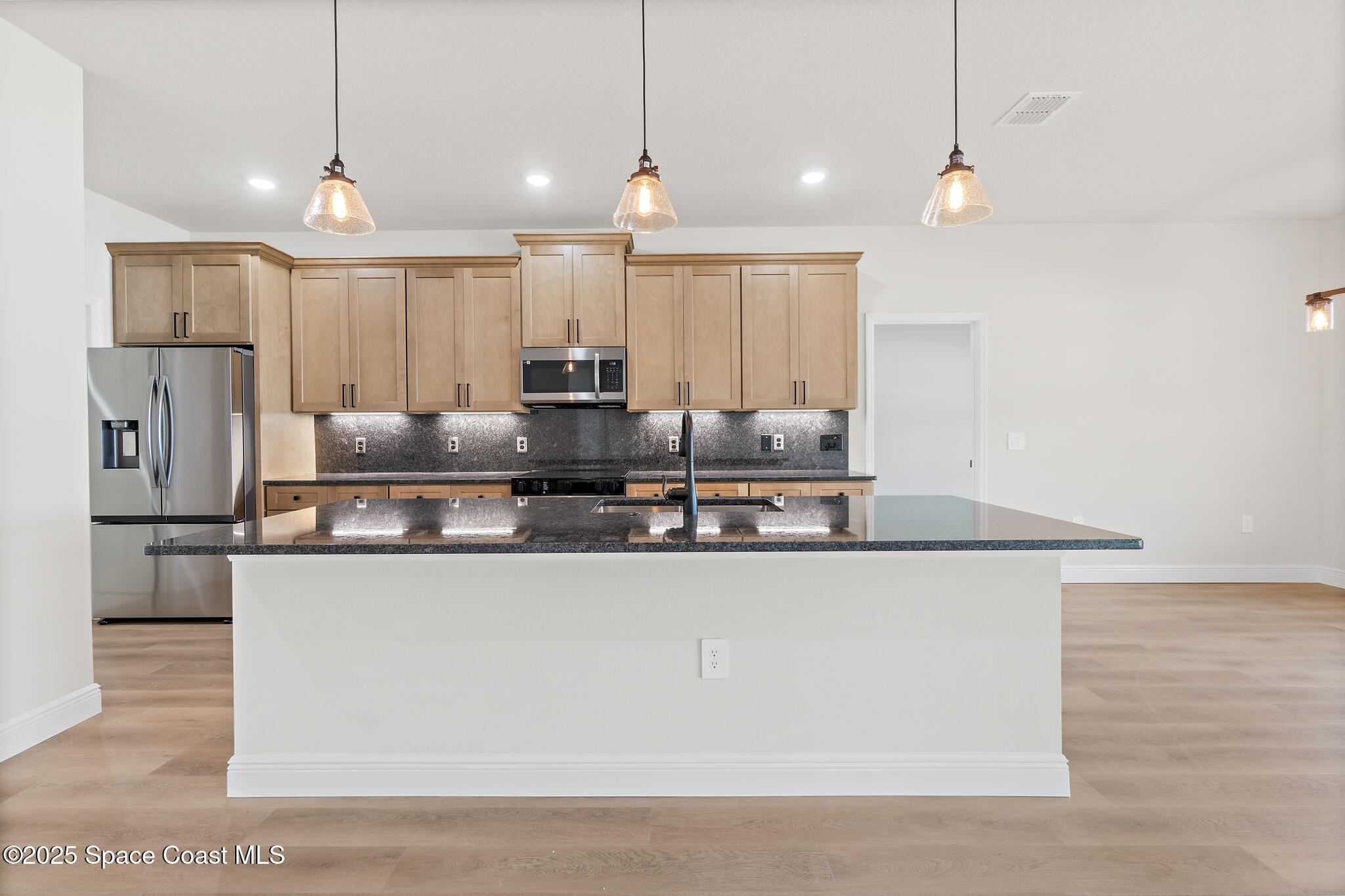 1541 Madison Road Northwest Palm Bay, FL 32907 - Photo 18 of 62 a large kitchen with stainless steel appliances kitchen island a large counter top and stove