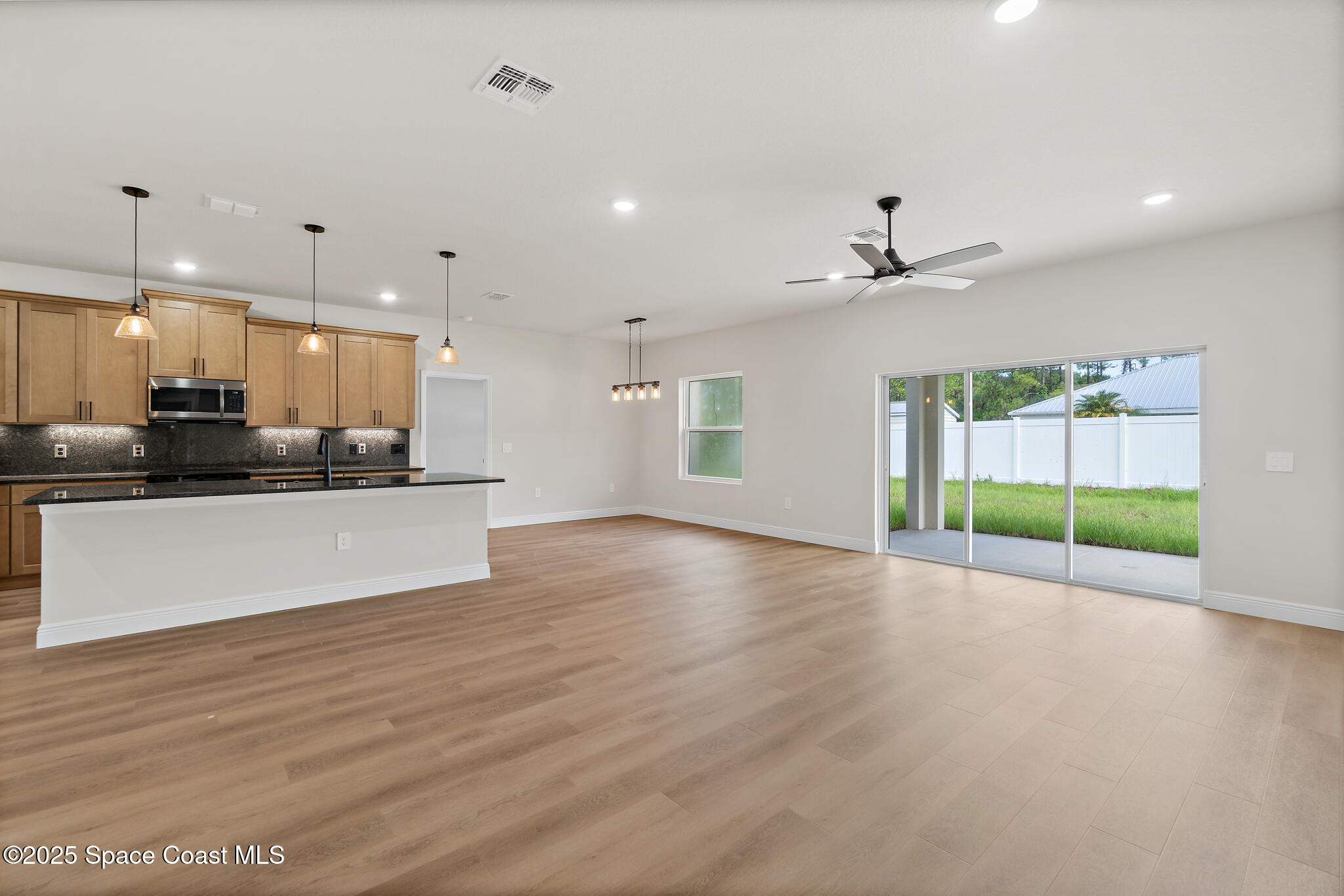 1541 Madison Road Northwest Palm Bay, FL 32907 - Photo 19 of 62 a view of kitchen with window and wooden floor