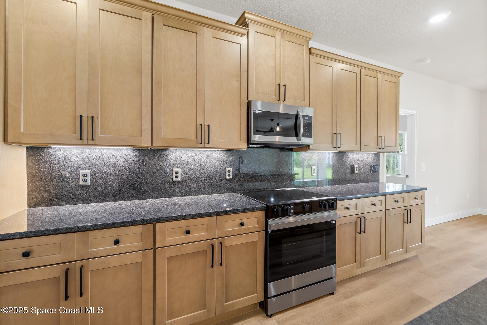 1541 Madison Road Northwest Palm Bay, FL 32907 - Photo 20 of 62 a kitchen with stainless steel appliances granite countertop a stove a sink and a white cabinets