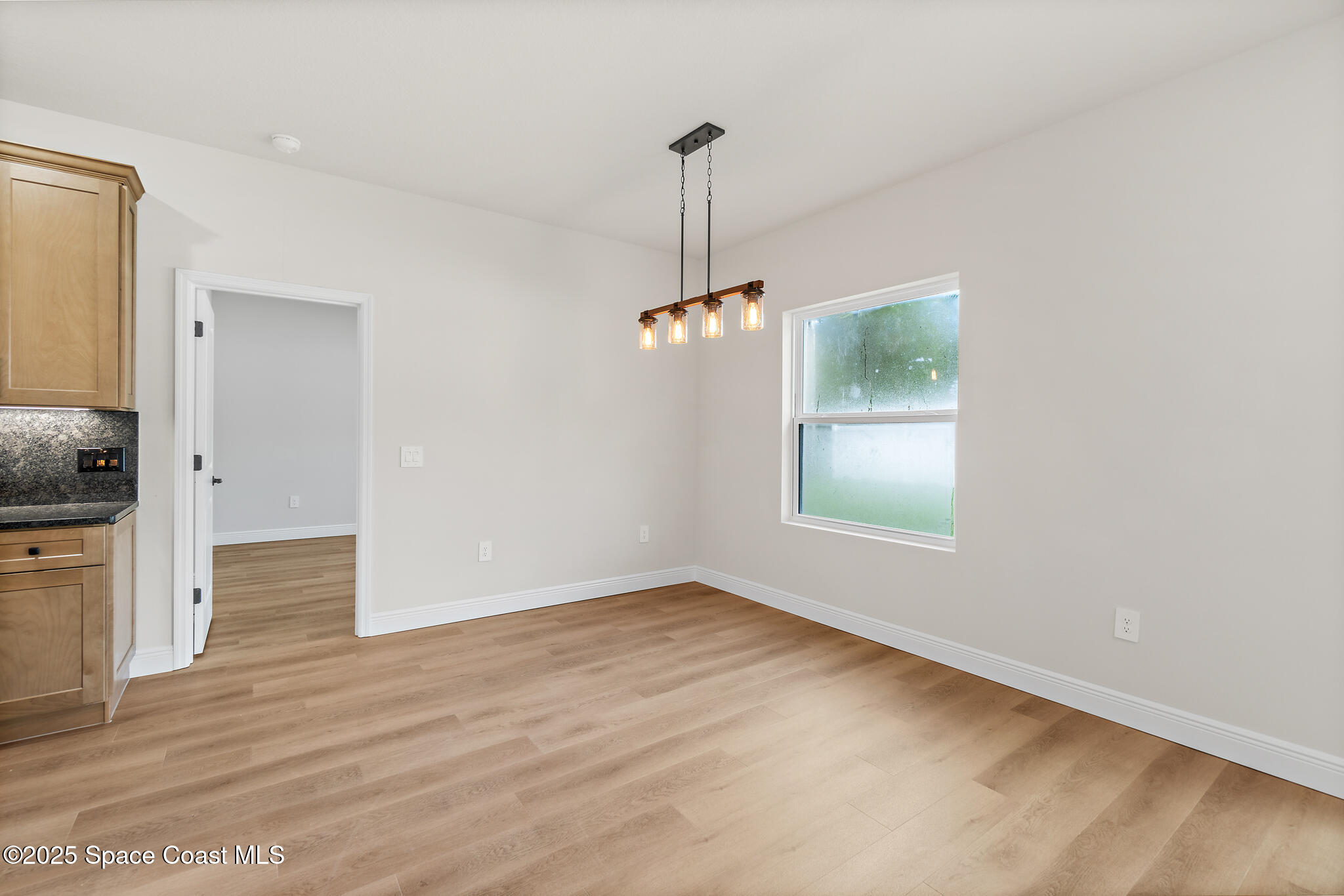 1541 Madison Road Northwest Palm Bay, FL 32907 - Photo 23 of 62 a view of an empty room with window and cabinet