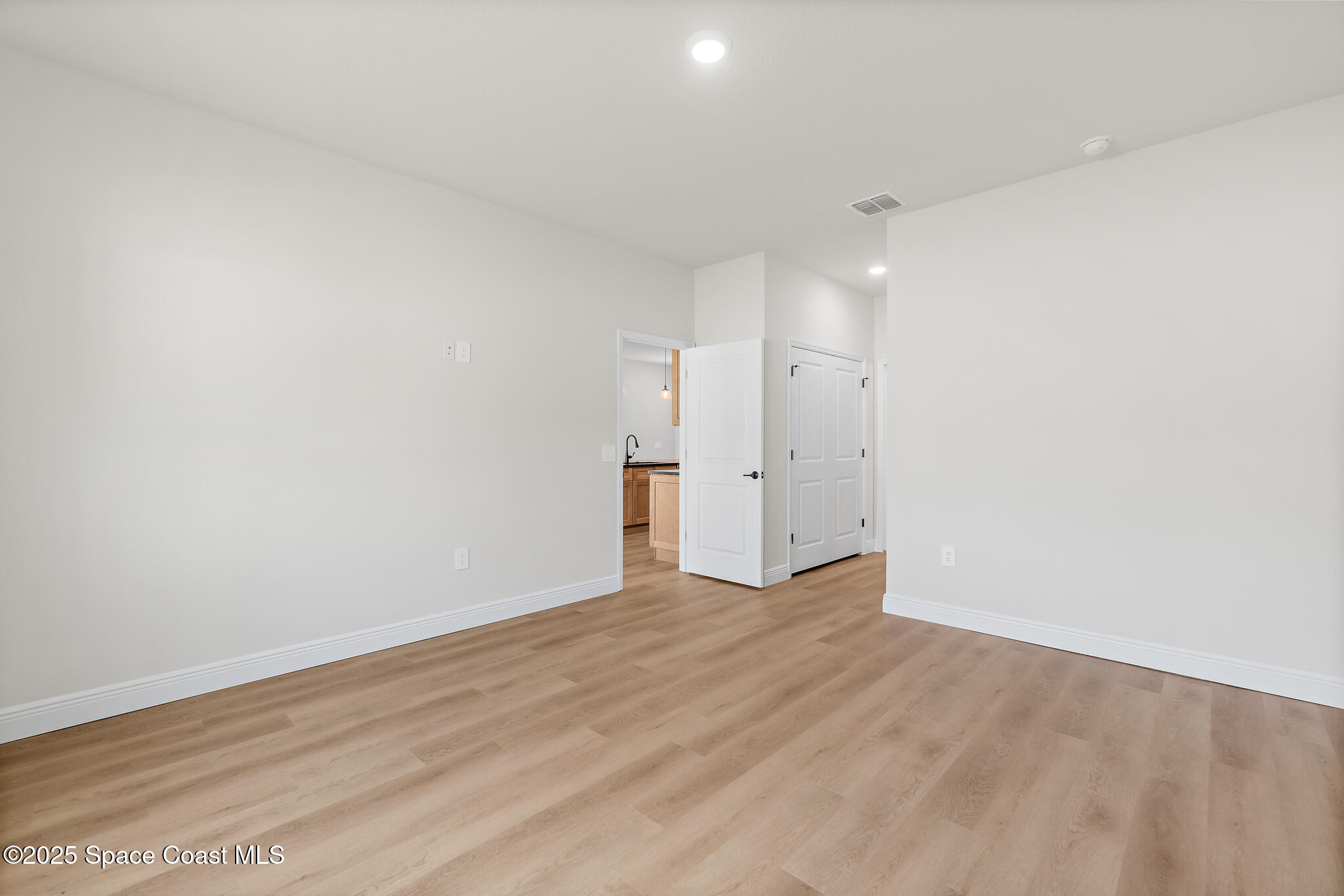 1541 Madison Road Northwest Palm Bay, FL 32907 - Photo 25 of 62 a view of an empty room with wooden floor