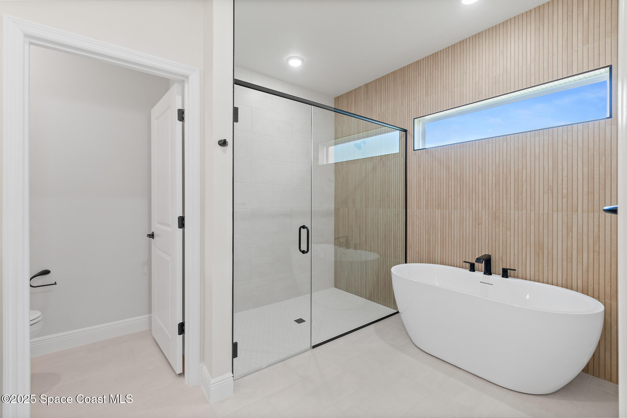 1541 Madison Road Northwest Palm Bay, FL 32907 - Photo 29 of 62 a bathroom with a tub and shower