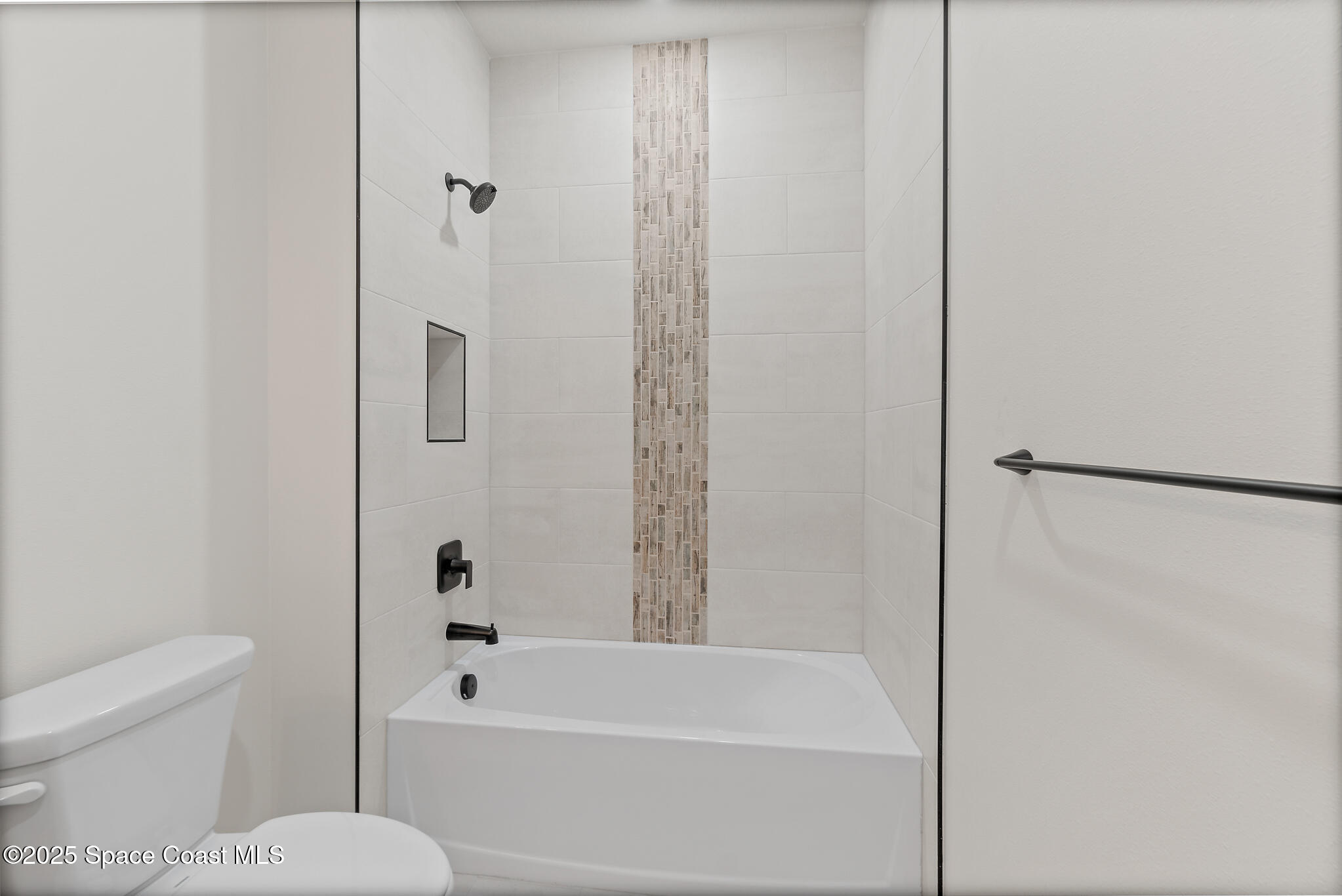 1541 Madison Road Northwest Palm Bay, FL 32907 - Photo 36 of 62 a bathroom with a toilet and a bathtub