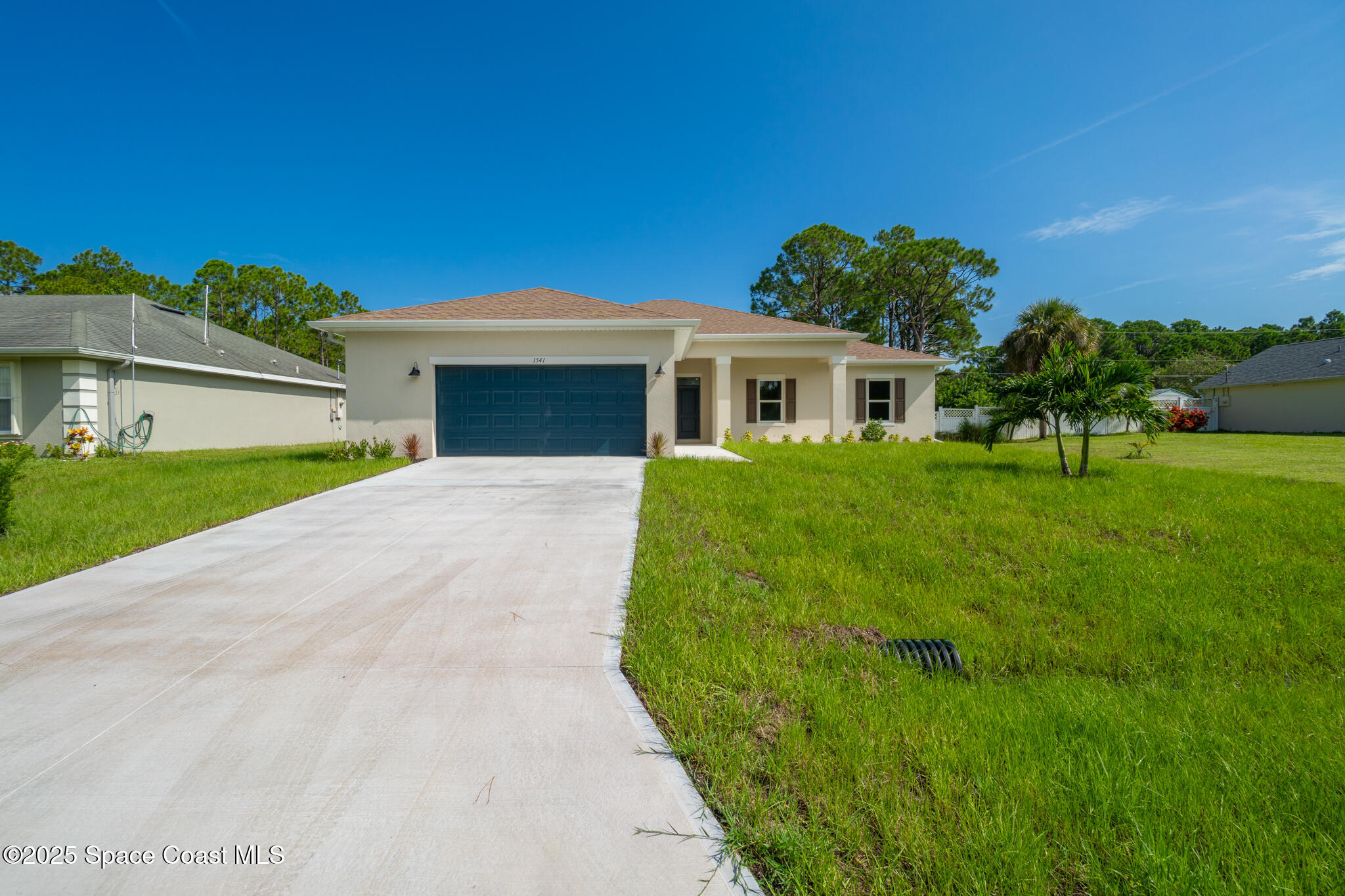 1541 Madison Road Northwest Palm Bay, FL 32907 - Photo 45 of 62 a view of house with a big yard and potted plants