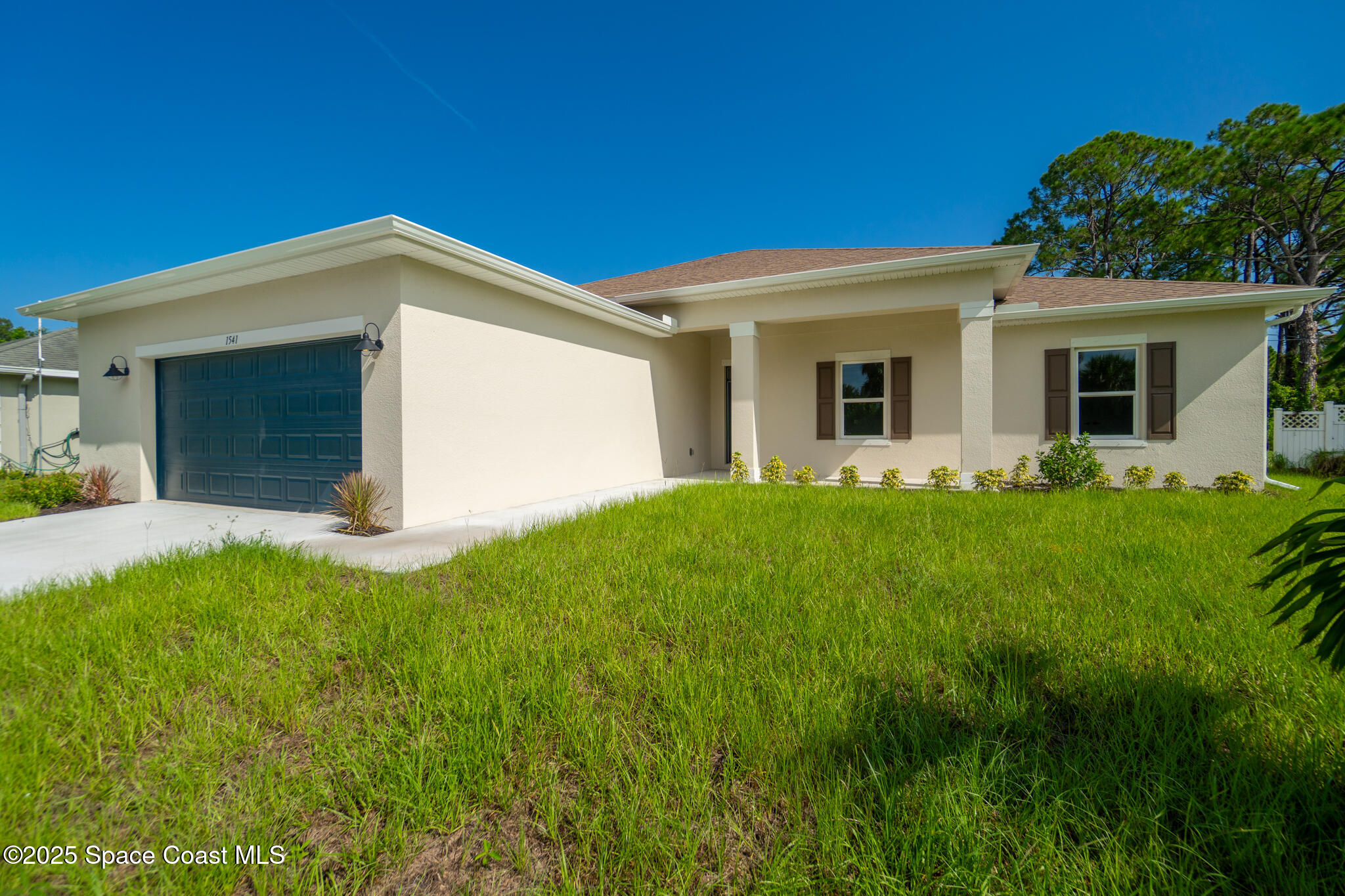 1541 Madison Road Northwest Palm Bay, FL 32907 - Photo 47 of 62 a view of a house with a yard