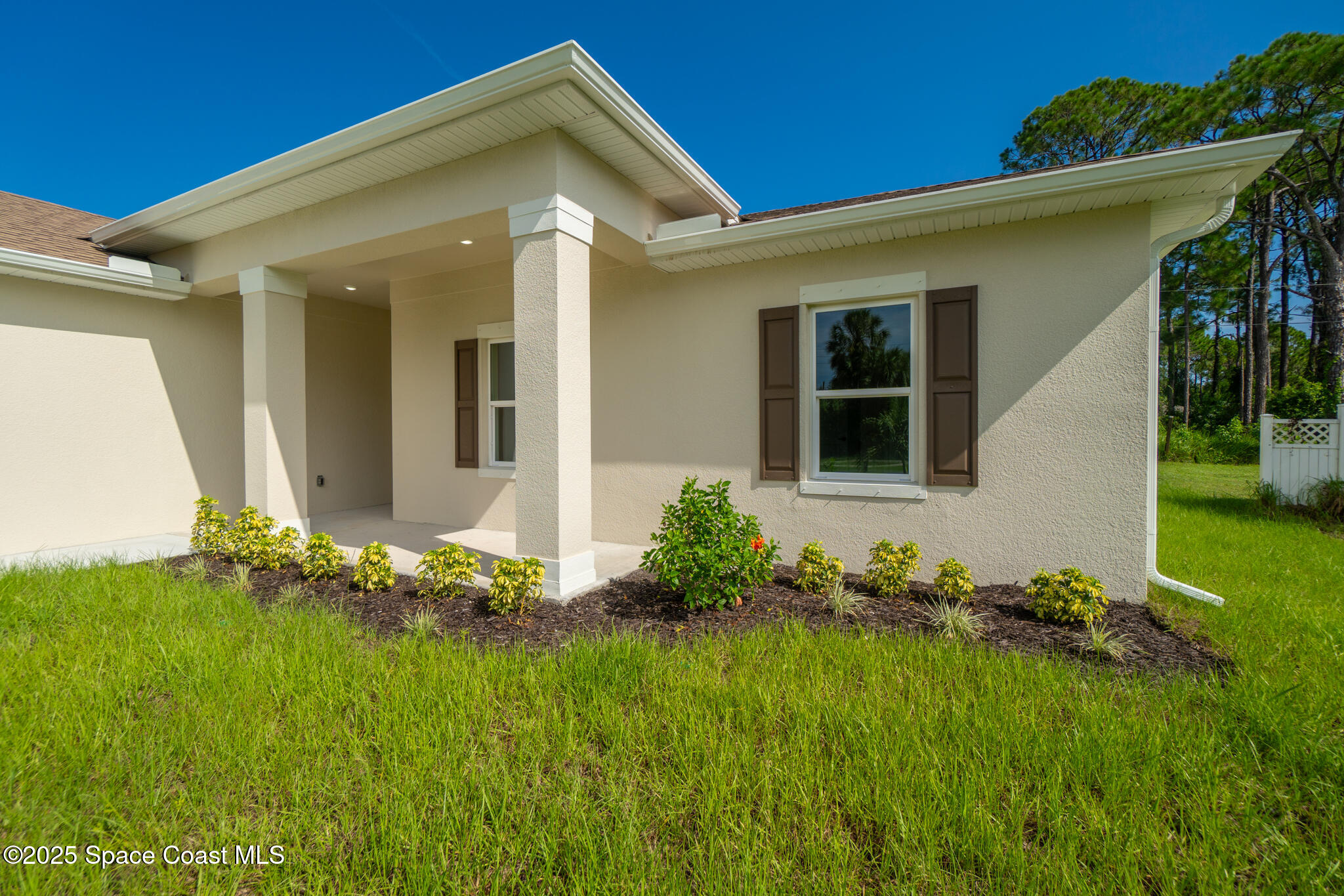 1541 Madison Road Northwest Palm Bay, FL 32907 - Photo 48 of 62 a front view of a house with garden