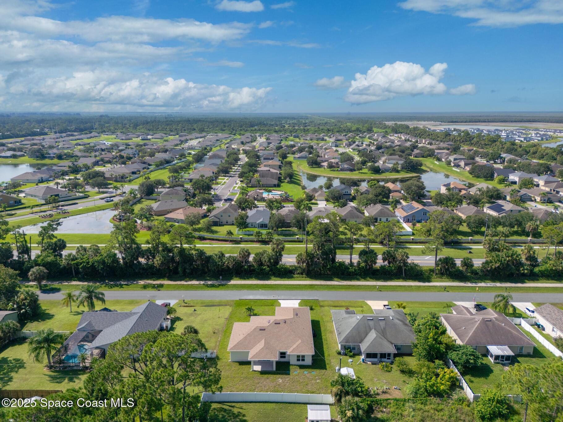 1541 Madison Road Northwest Palm Bay, FL 32907 - Photo 5 of 62 an aerial view of a city with lots of residential buildings swimming pool and green space