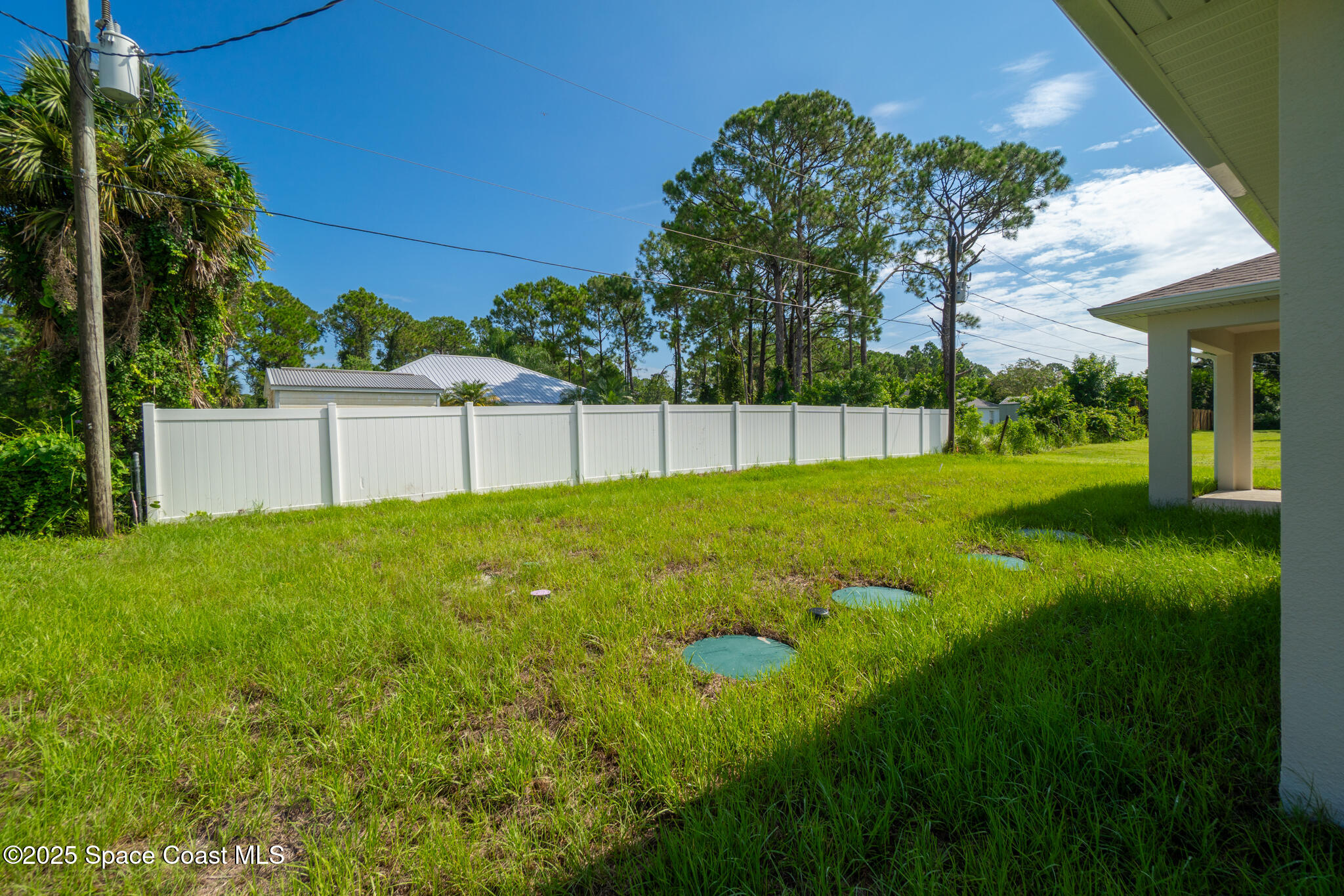 1541 Madison Road Northwest Palm Bay, FL 32907 - Photo 51 of 62 a view of a backyard with a garden and entertaining space