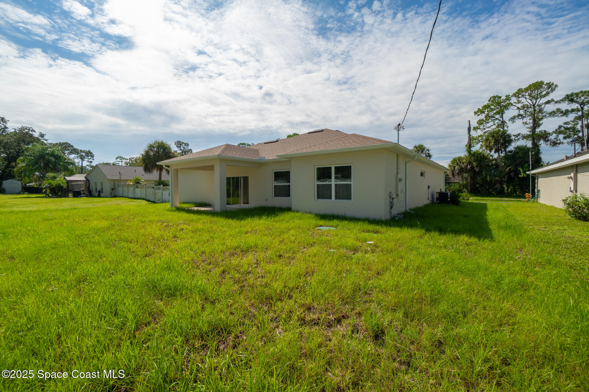 1541 Madison Road Northwest Palm Bay, FL 32907 - Photo 52 of 62 a view of a house with a backyard