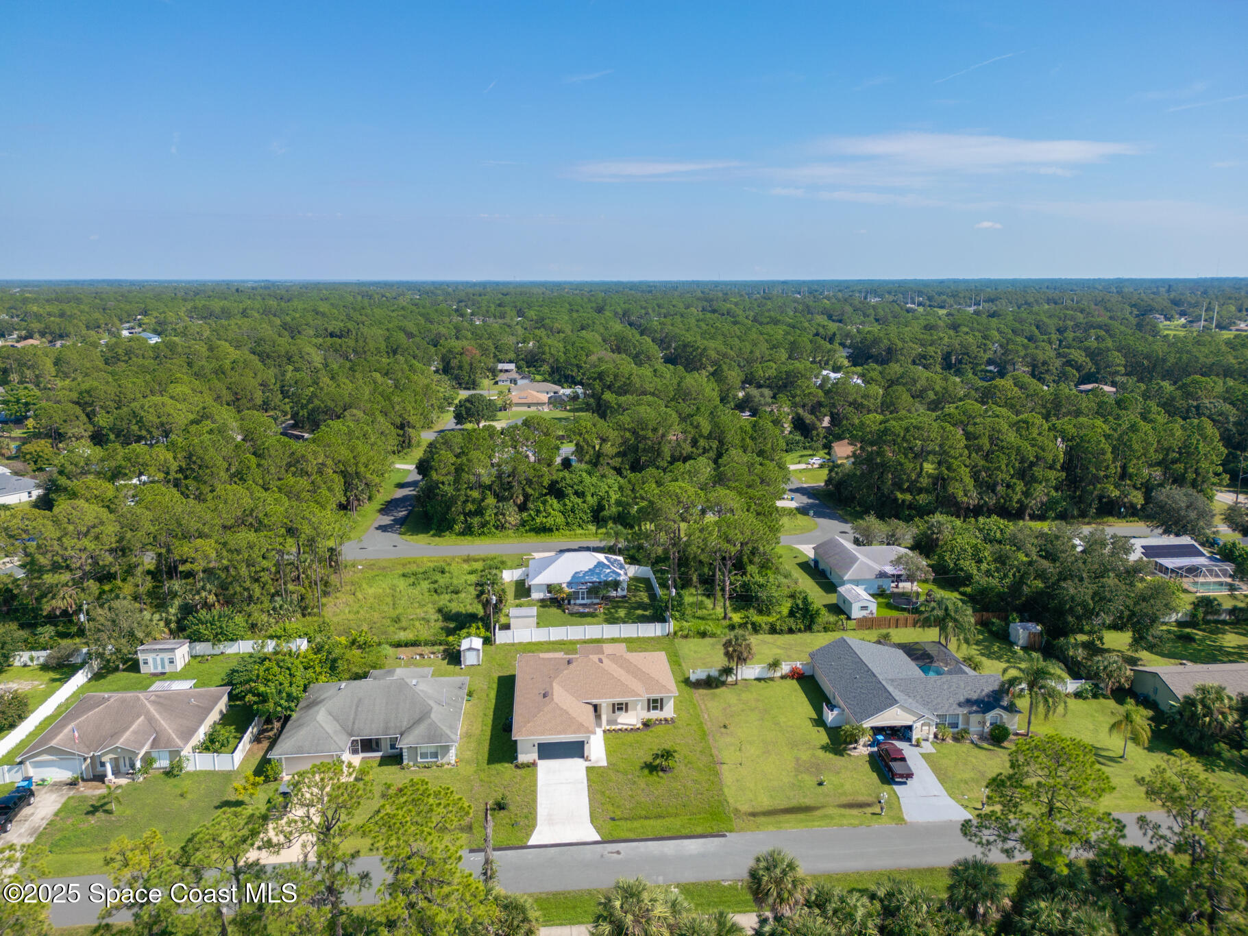 1541 Madison Road Northwest Palm Bay, FL 32907 - Photo 58 of 62 an aerial view of a houses with outdoor space and trees all around