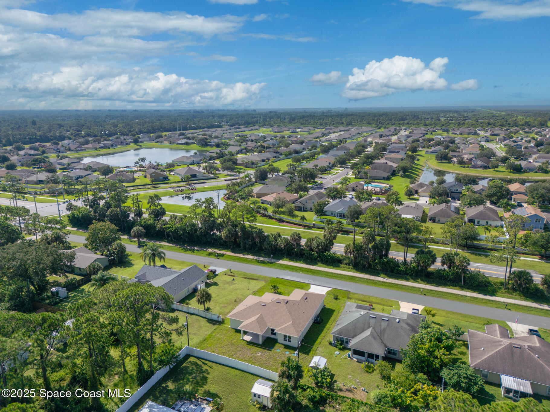 1541 Madison Road Northwest Palm Bay, FL 32907 - Photo 62 of 62 an aerial view of residential houses with outdoor space and swimming pool