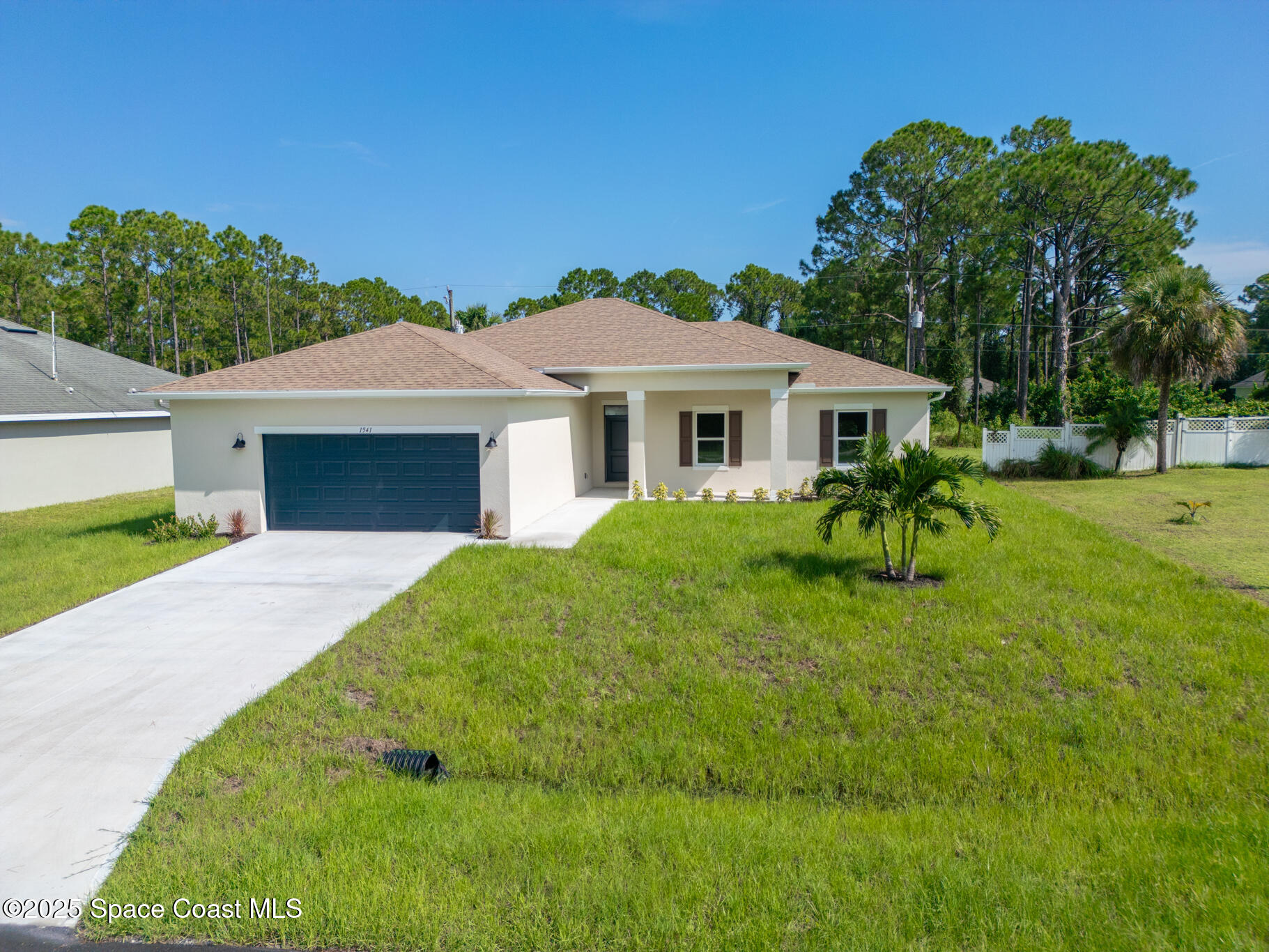1541 Madison Road Northwest Palm Bay, FL 32907 - Photo 9 of 62 a front view of a house with a yard