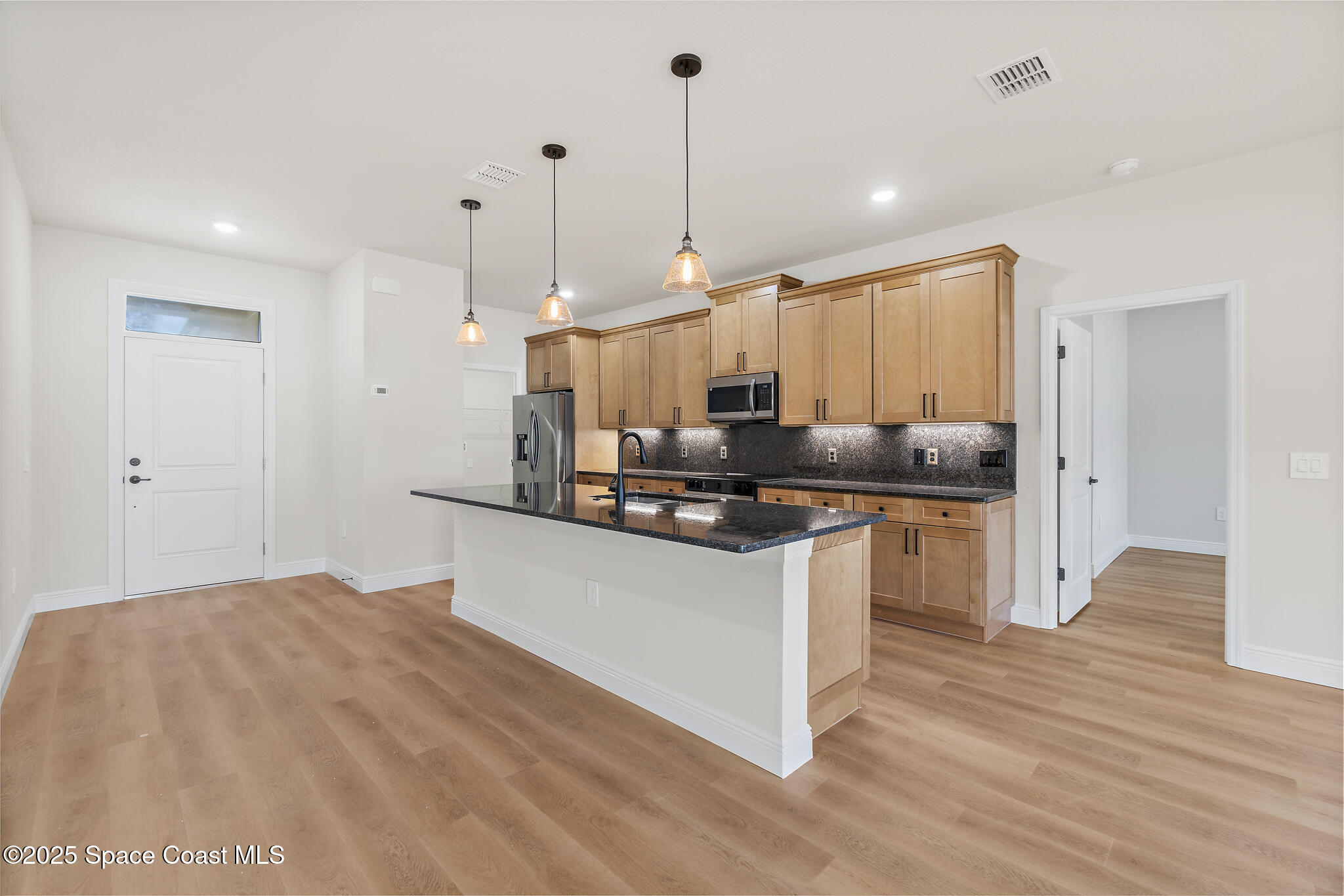 1541 Madison Road Northwest Palm Bay, FL 32907 - Photo 10 of 62 a kitchen with kitchen island a sink a counter top space and stainless steel appliances