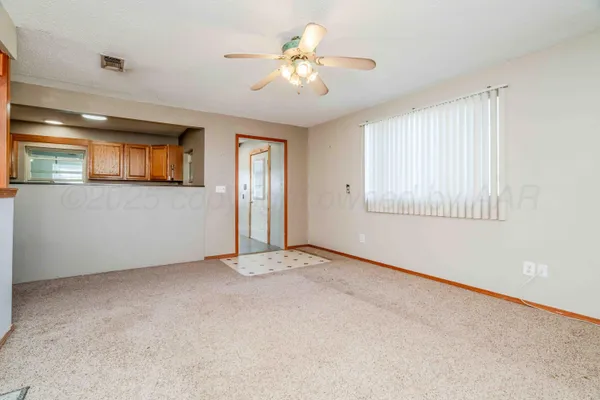 en empty room with closet and a chandelier fan