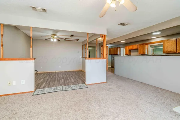 a kitchen with kitchen island granite countertop wooden cabinets and white appliances