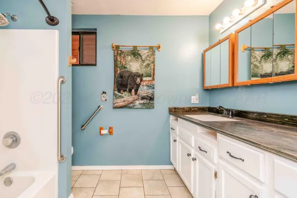 a bathroom with a sink and a window