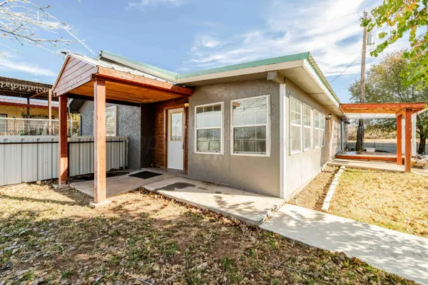 a view of a house with wooden floor and wooden fence