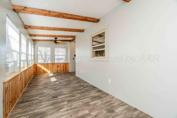 an empty room with closet and a chandelier fan