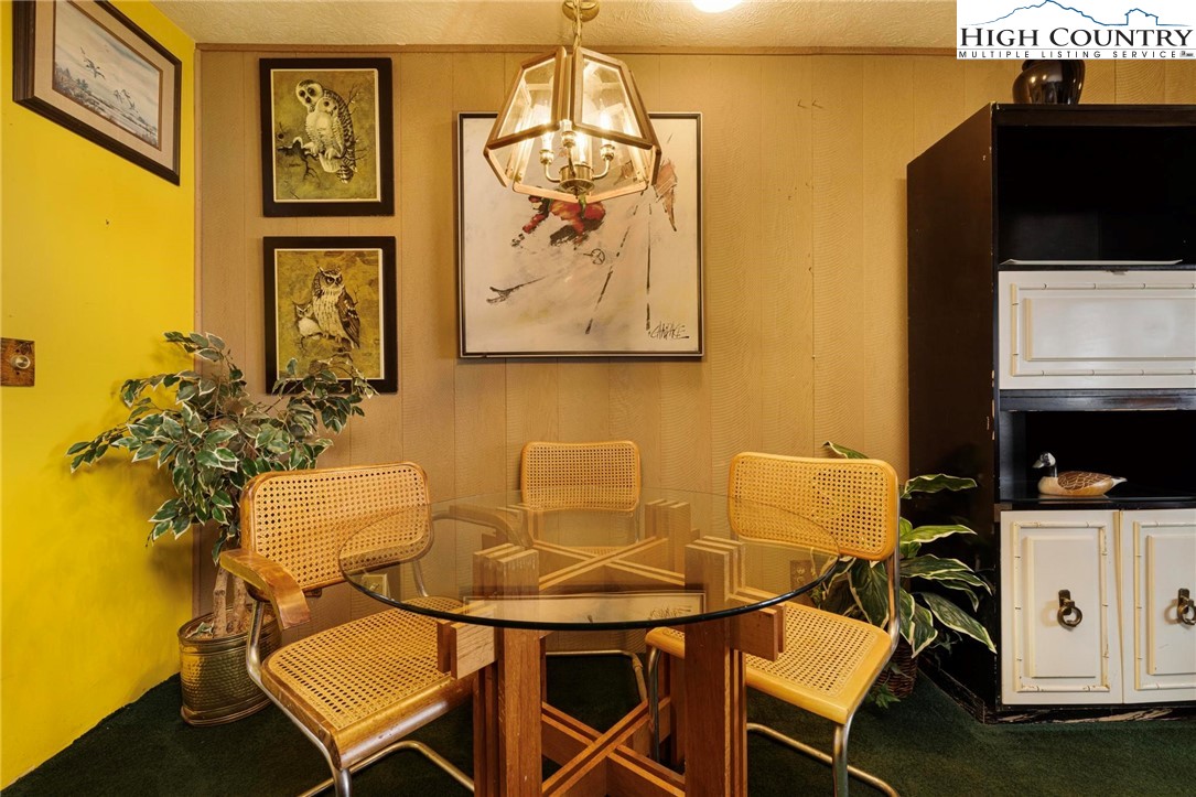 220 Northridge Road, Unit D15 Beech Mountain, NC 28604 - Photo 11 of 47 a view of a dining room with furniture and a flat screen tv