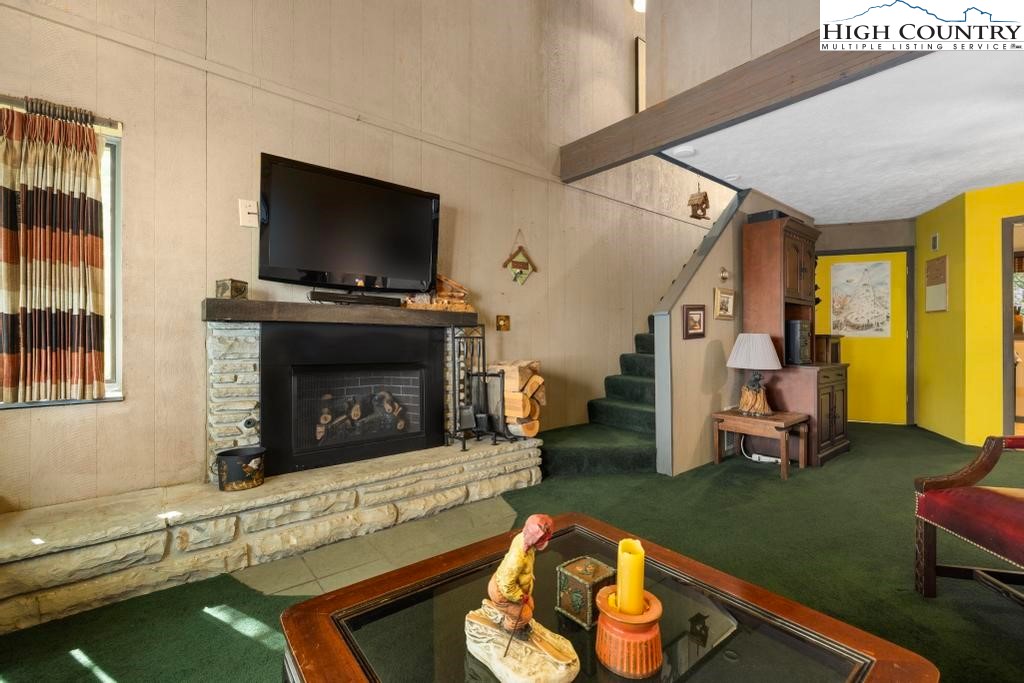 220 Northridge Road, Unit D15 Beech Mountain, NC 28604 - Photo 19 of 47 a living room with furniture a flat screen tv and a fireplace