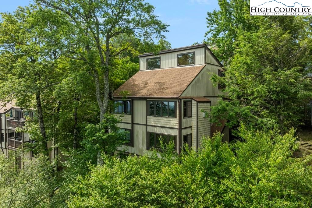 220 Northridge Road, Unit D15 Beech Mountain, NC 28604 - Photo 2 of 47 a view of a house with pool and garden