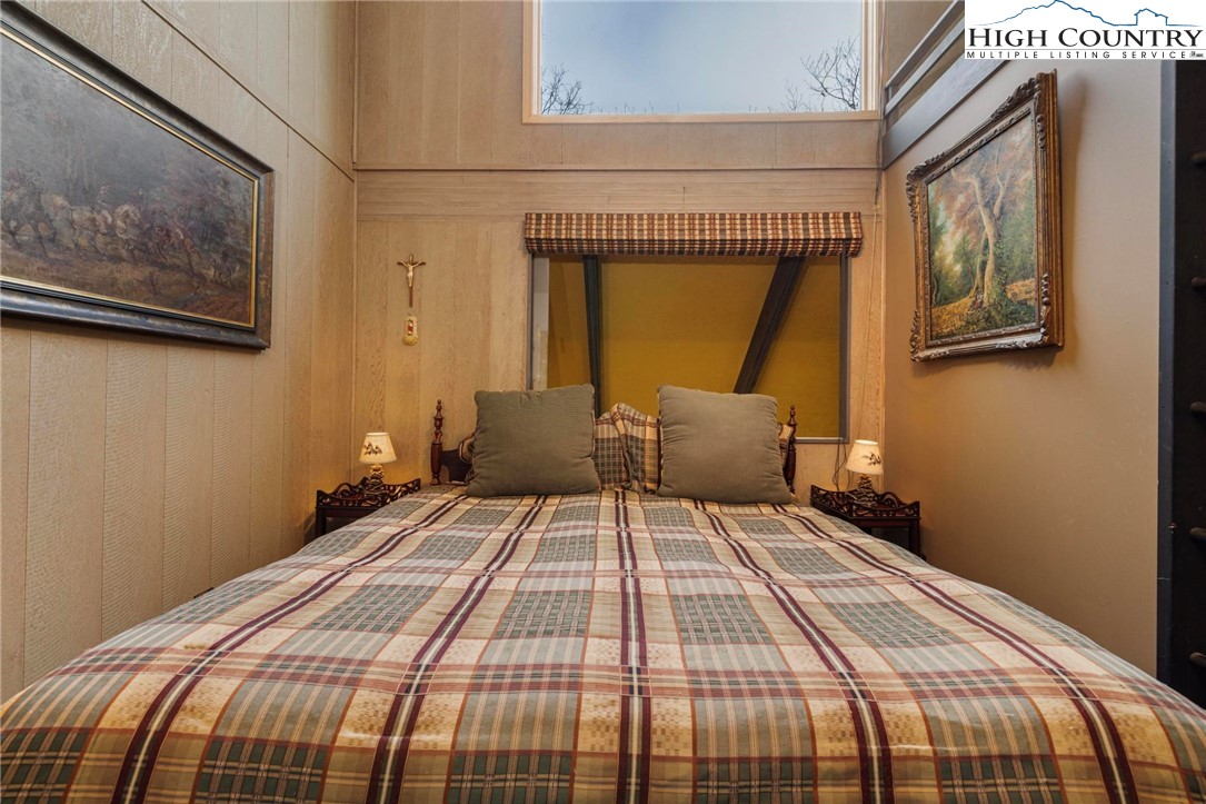 220 Northridge Road, Unit D15 Beech Mountain, NC 28604 - Photo 22 of 47 a bedroom with a bed and wooden floor