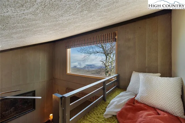 a balcony with wooden floor and trees