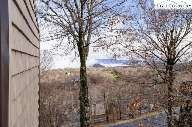 an aerial view of a house with a yard and lake view