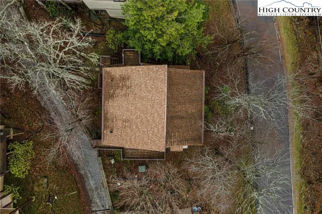 an aerial view of a house with a yard