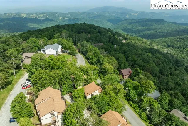an aerial view of a house with yard
