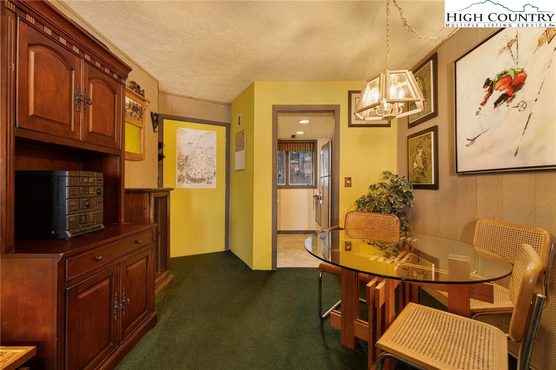 220 Northridge Road, Unit D15 Beech Mountain, NC 28604 - Photo 10 of 47 a living room with furniture and a flat screen tv