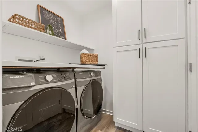 a view of a patio with table and chairs with wooden floor and fence