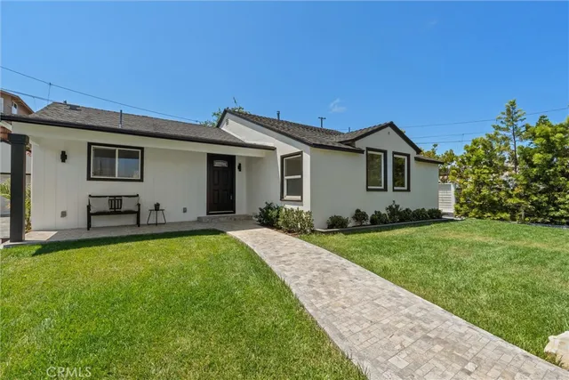a view of a patio with table and chairs potted plants with wooden floor and fence