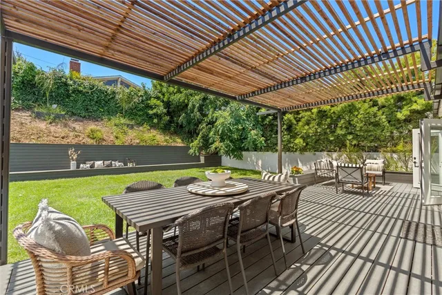 a front view of a house with swimming pool having outdoor seating
