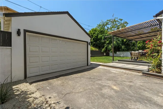 an aerial view of a house with a garden and a car parked