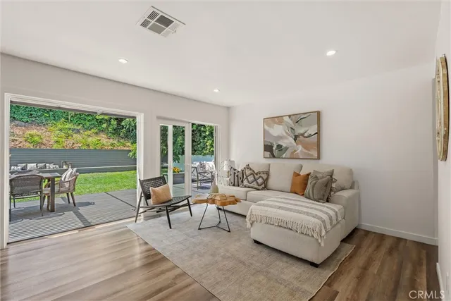a utility room with wooden floor and large windows