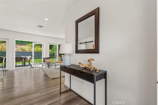 a living room with furniture a large window and a potted plant