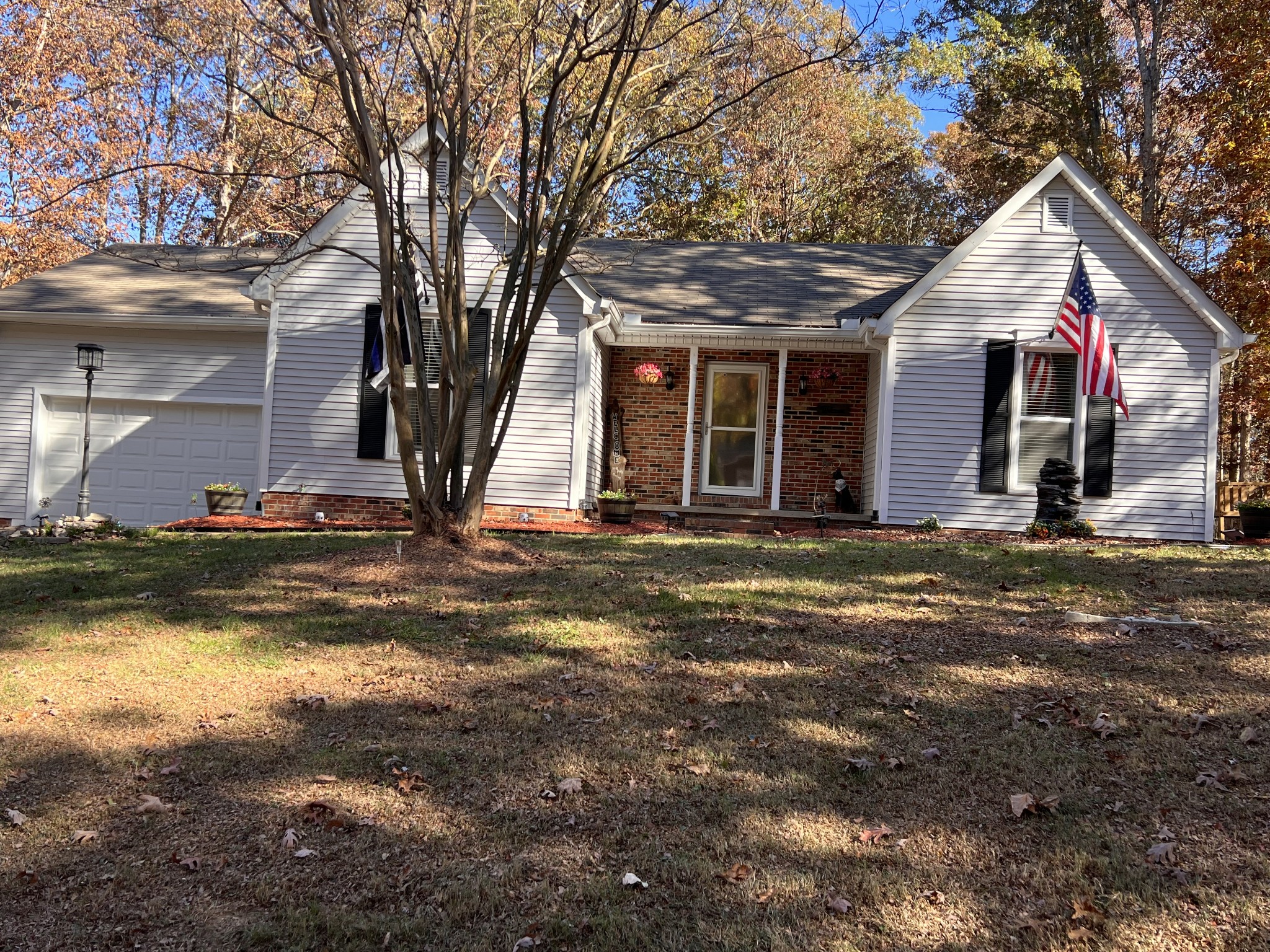 a view of a house with yard and sitting area