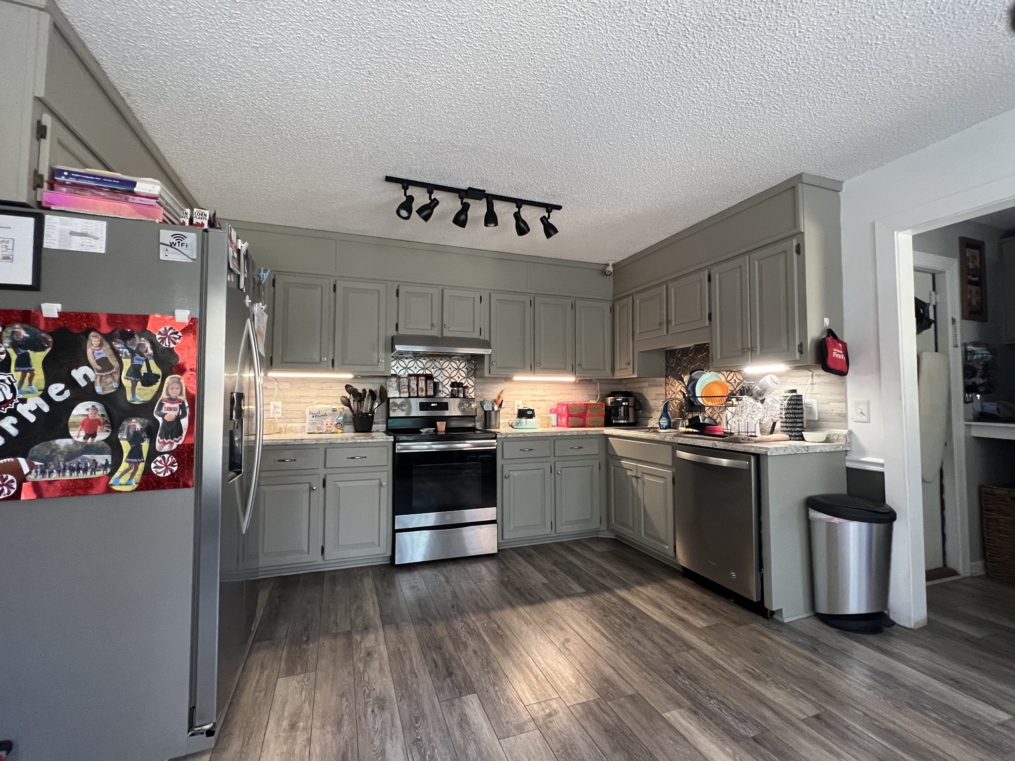 3510 Flag Drive Centerville, TN 37033 - Photo 5 of 11 a kitchen with stainless steel appliances kitchen island granite countertop a refrigerator stove and wooden floor