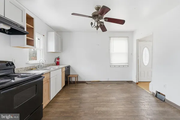 a kitchen with granite countertop a sink stainless steel appliances and cabinets