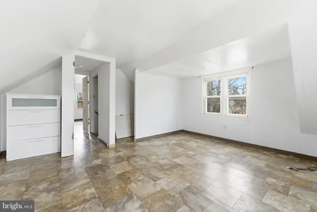 an empty room with a empty space and windows