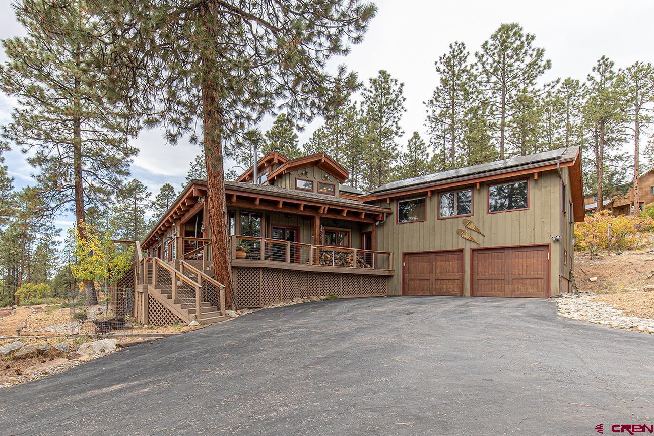 375 Nusbaum Road Durango, CO 81301 - Photo 1 of 33 a view of a house with a large window and wooden fence