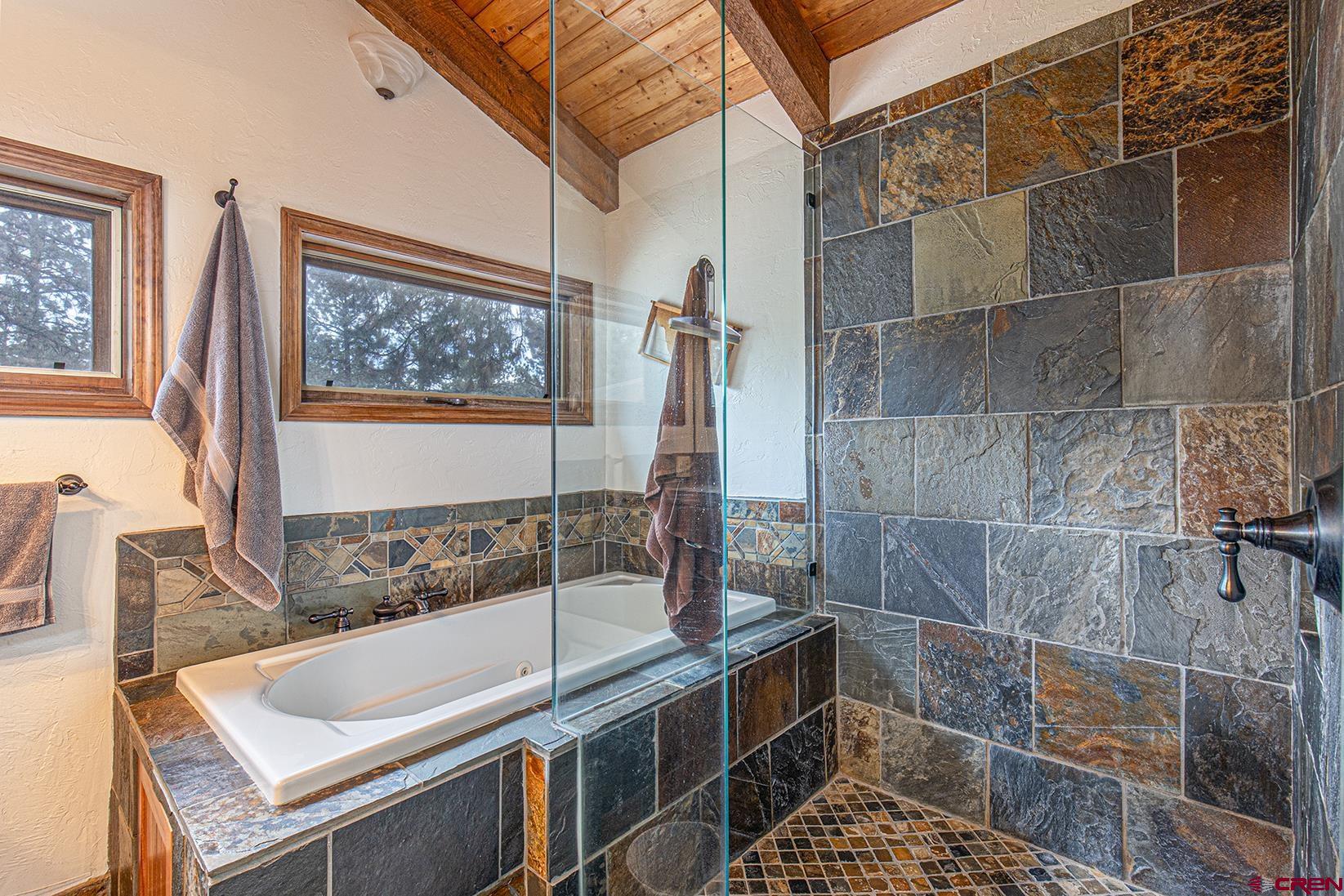 375 Nusbaum Road Durango, CO 81301 - Photo 17 of 33 a bathroom with a tub a sink and a window