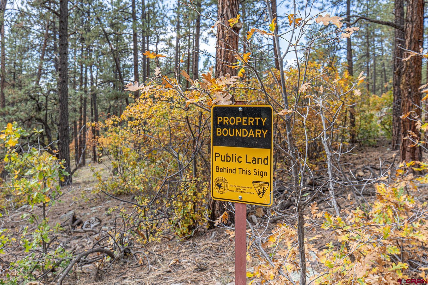 375 Nusbaum Road Durango, CO 81301 - Photo 2 of 33 a sign that is sitting on a brick wall