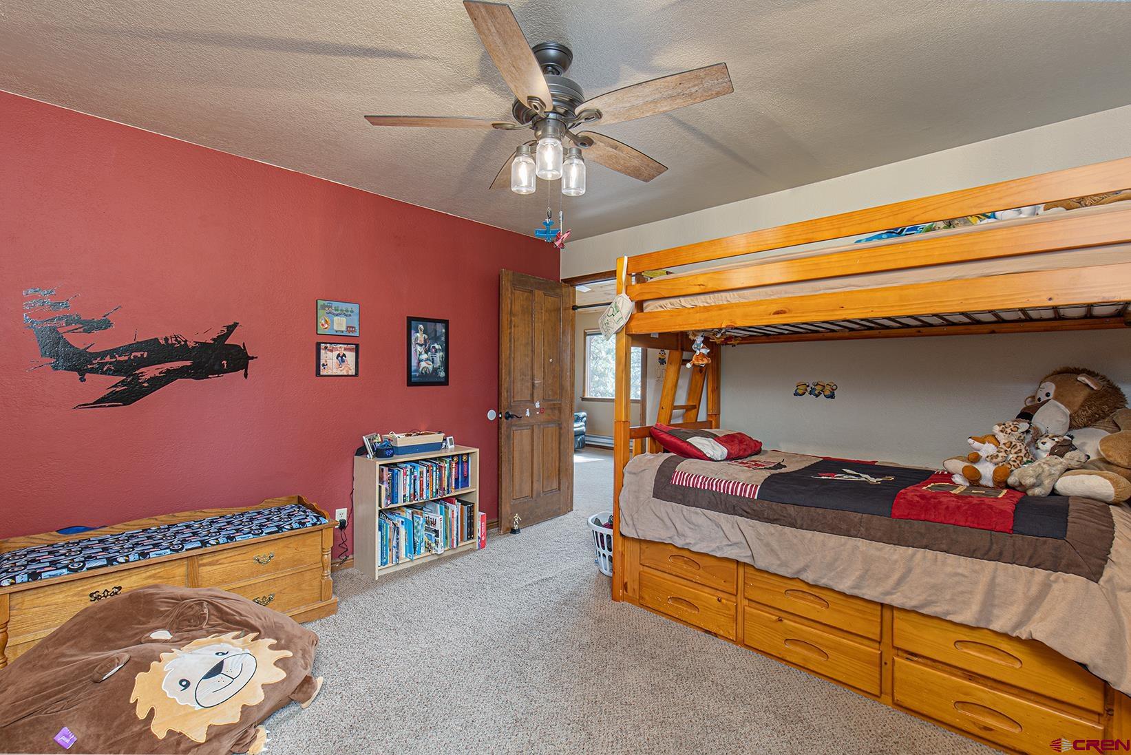 375 Nusbaum Road Durango, CO 81301 - Photo 23 of 33 a bedroom with a bed and ceiling fan